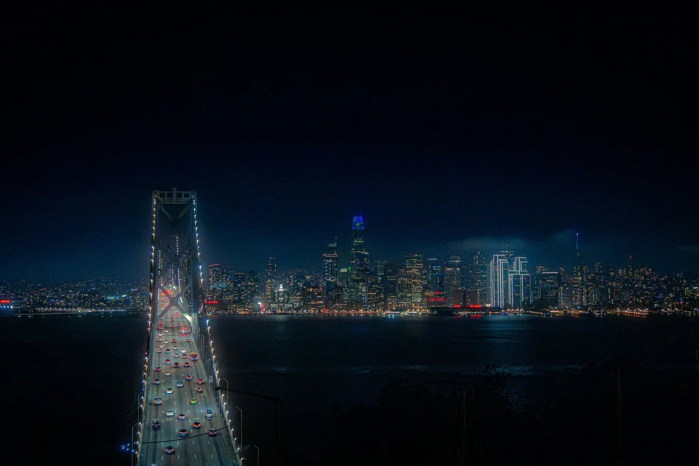 San Francisco skyline at night viewed across the Bay Bridge.